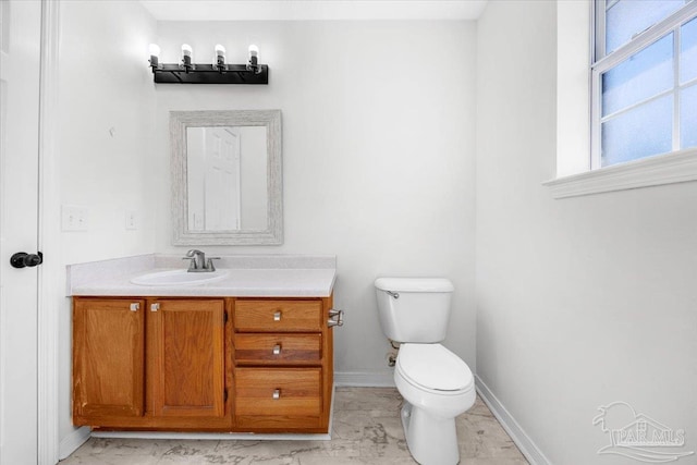 6914 Raburn Rd, Pensacola, FL 32526 - half bath with vanity, marble finish floor, baseboards, and toilet