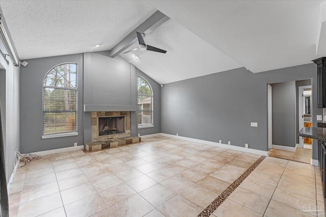 unfurnished living room featuring a textured ceiling, lofted ceiling with beams, a wealth of natural light, and ceiling fan