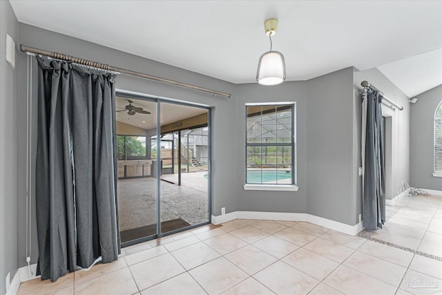 unfurnished dining area featuring lofted ceiling, ceiling fan, and light tile patterned floors