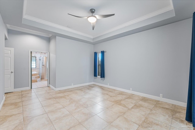 spare room featuring a tray ceiling, ceiling fan, and ornamental molding