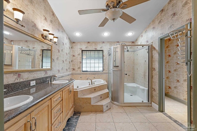 bathroom with tile patterned flooring, vanity, ceiling fan, and plus walk in shower