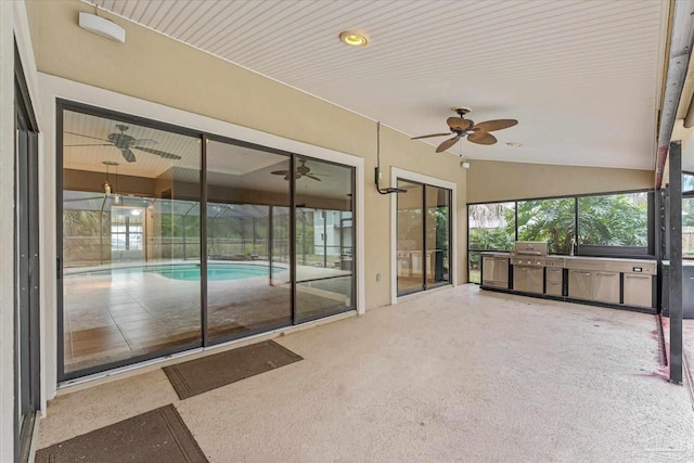 unfurnished sunroom with lofted ceiling and a pool