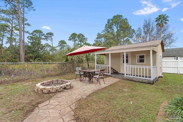 exterior space with an outbuilding and an outdoor fire pit