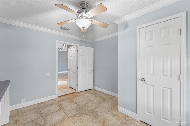 unfurnished bedroom with a textured ceiling, ceiling fan, light tile patterned floors, and crown molding