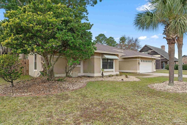 view of front of home with a garage and a front lawn