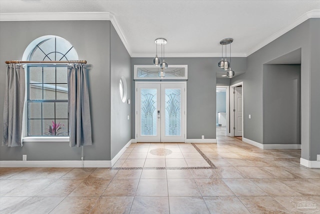 foyer with light tile patterned flooring, ornamental molding, and french doors