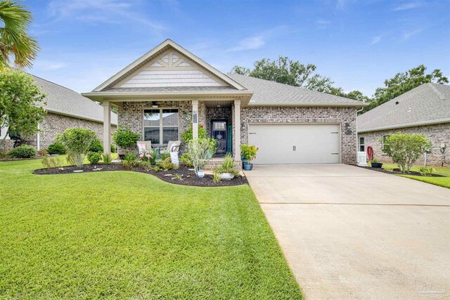 view of front facade with a garage, a front lawn, and ceiling fan