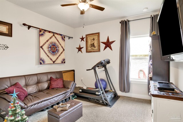 workout area featuring a healthy amount of sunlight, ceiling fan, and carpet