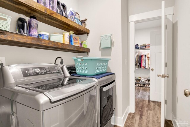 laundry room with separate washer and dryer and light wood-type flooring