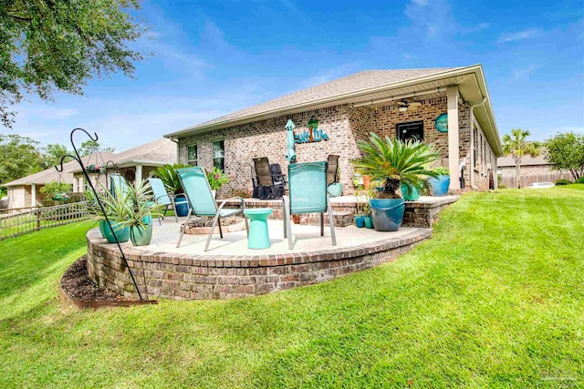 back of house featuring a yard, ceiling fan, and a patio area