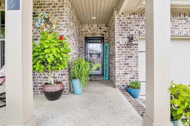 entrance to property with a garage and covered porch