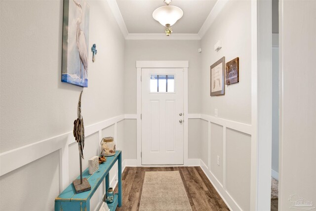 doorway with ornamental molding and wood-type flooring