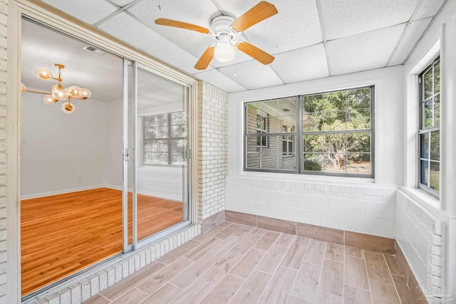 7332 Maxam Ave, Pensacola, FL 32503 - unfurnished sunroom featuring ceiling fan with notable chandelier and a drop ceiling