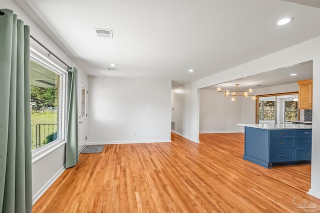 7332 Maxam Ave, Pensacola, FL 32503 - interior space with light wood-type flooring, a wealth of natural light, and an inviting chandelier