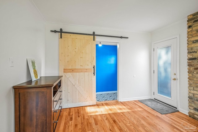 7332 Maxam Ave, Pensacola, FL 32503 - foyer entrance featuring a barn door, crown molding, and wood-type flooring