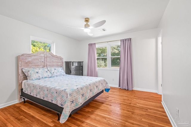 7332 Maxam Ave, Pensacola, FL 32503 - bedroom with multiple windows, ceiling fan, and wood-type flooring