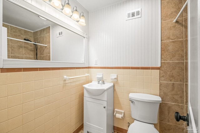 7332 Maxam Ave, Pensacola, FL 32503 - bathroom featuring vanity, toilet, tiled shower, and tile walls