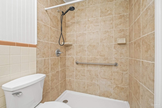 7332 Maxam Ave, Pensacola, FL 32503 - bathroom featuring toilet, a tile shower, and tile walls