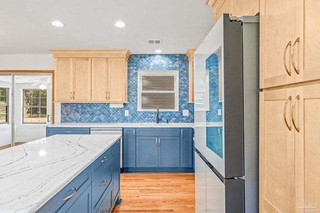 7332 Maxam Ave, Pensacola, FL 32503 - kitchen featuring stainless steel fridge, light brown cabinetry, light hardwood / wood-style flooring, and sink