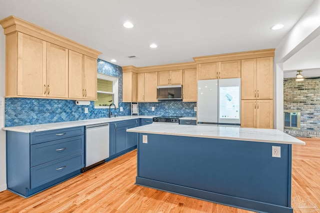 7332 Maxam Ave, Pensacola, FL 32503 - kitchen featuring light brown cabinets, light wood-type flooring, stainless steel appliances, and a kitchen island