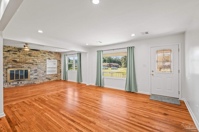 7332 Maxam Ave, Pensacola, FL 32503 - unfurnished living room featuring a fireplace, light wood-type flooring, and ceiling fan