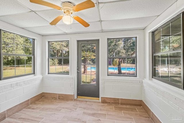 7332 Maxam Ave, Pensacola, FL 32503 - unfurnished sunroom featuring a paneled ceiling, ceiling fan, and a healthy amount of sunlight