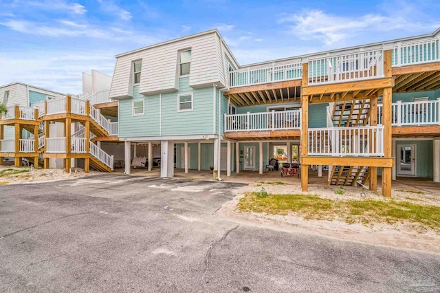 1100 Ft Pickens Rd Unit A-21, Pensacola Beach, FL 32561 - rear view of house featuring stairs and a carport