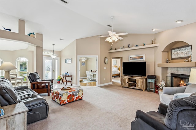 carpeted living room featuring ceiling fan, lofted ceiling, and a fireplace