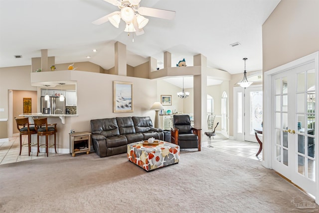 carpeted living room with ceiling fan with notable chandelier, lofted ceiling, and french doors