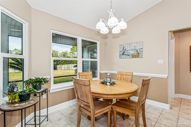 tiled dining room featuring an inviting chandelier