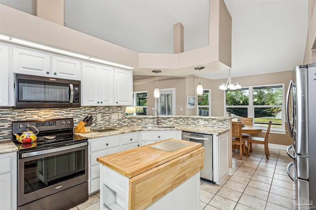 kitchen featuring pendant lighting, white cabinets, sink, and stainless steel appliances