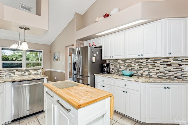 kitchen featuring white cabinets, lofted ceiling, and appliances with stainless steel finishes