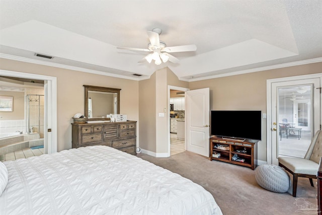 carpeted bedroom featuring ceiling fan, crown molding, connected bathroom, and a tray ceiling