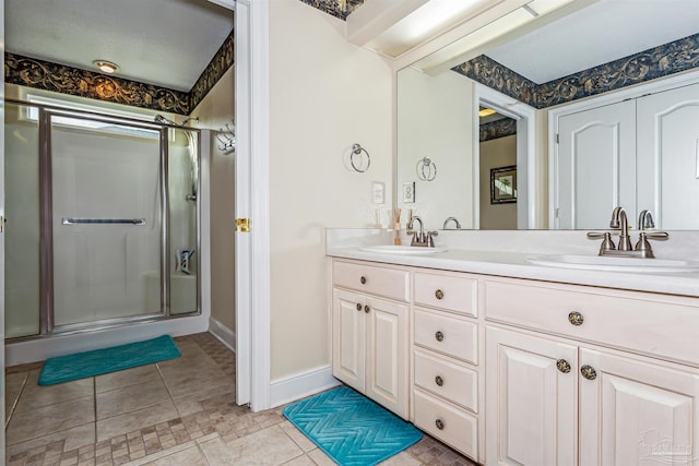 bathroom with vanity and a shower with door