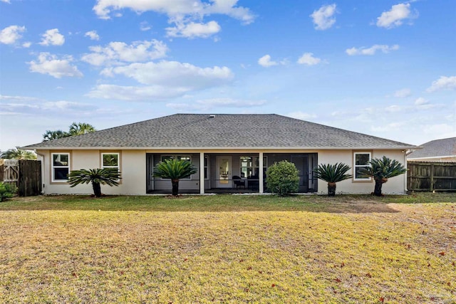 rear view of house featuring a lawn