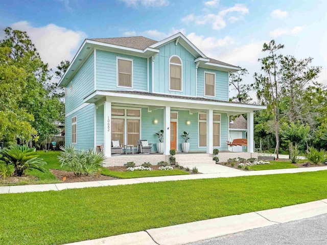 view of front of property featuring covered porch and a front lawn