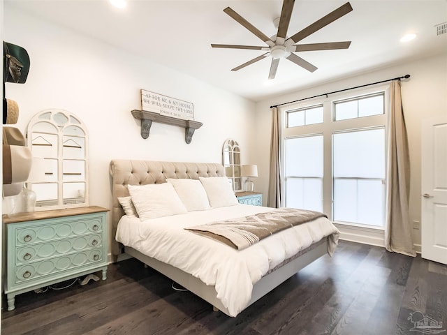 bedroom with dark wood-type flooring, ceiling fan, and multiple windows