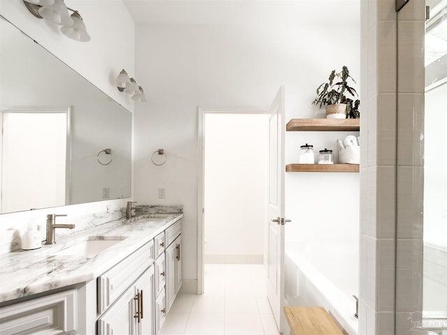 bathroom featuring vanity, a bathtub, and tile patterned floors