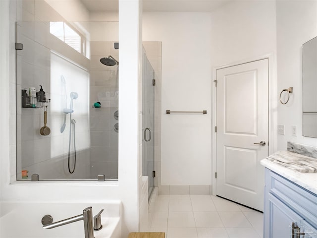 bathroom featuring a shower with door, vanity, and tile patterned flooring