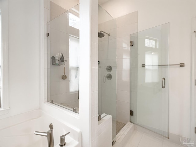 bathroom featuring tile patterned flooring, separate shower and tub, and sink