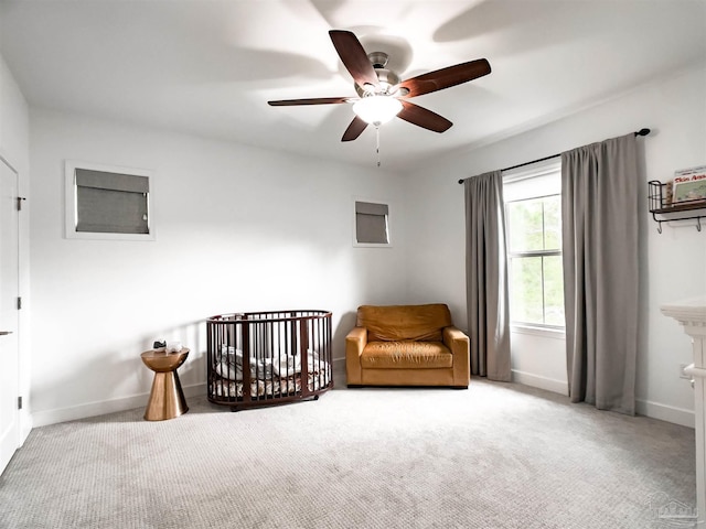 living area with ceiling fan and light carpet