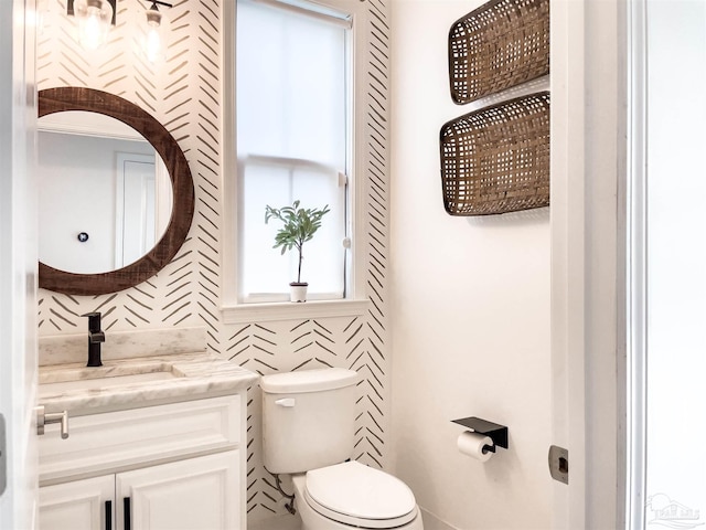 bathroom featuring vanity and toilet