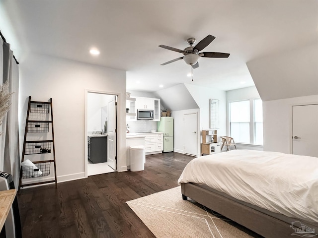 bedroom with white refrigerator, dark hardwood / wood-style flooring, ensuite bathroom, and ceiling fan