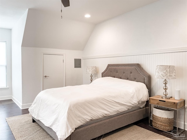 bedroom featuring vaulted ceiling, dark hardwood / wood-style floors, electric panel, and ceiling fan