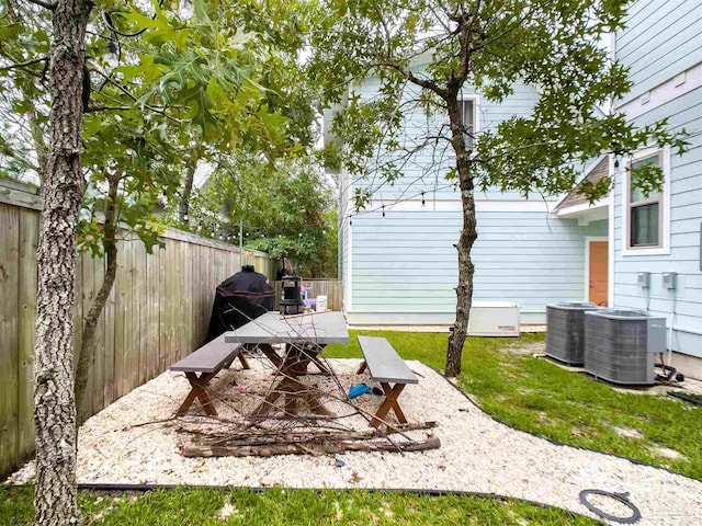 view of yard with central AC unit and a patio