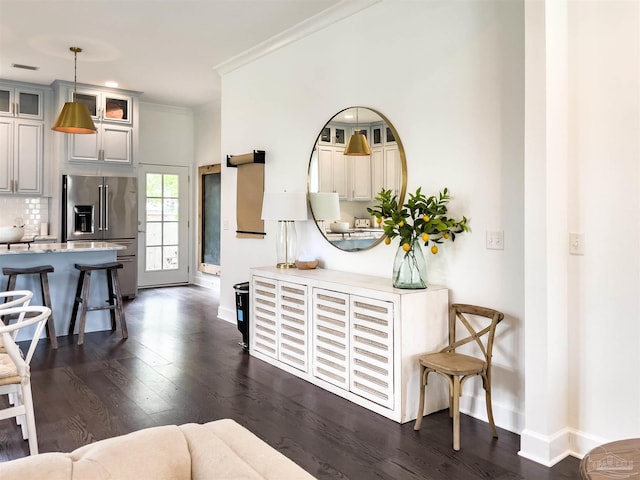 interior space featuring ornamental molding and dark hardwood / wood-style flooring