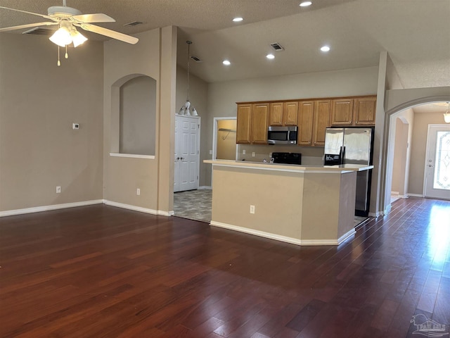 kitchen featuring visible vents, appliances with stainless steel finishes, arched walkways, and dark wood-type flooring