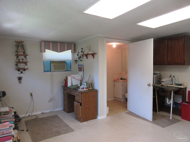 kitchen featuring a textured ceiling, cooling unit, and dark brown cabinets