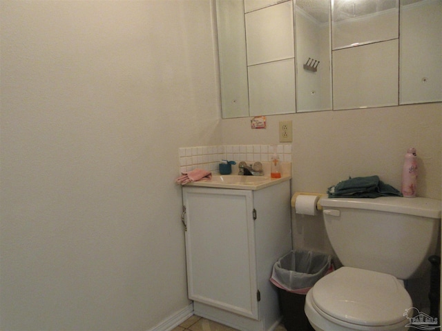 bathroom featuring backsplash, toilet, and vanity