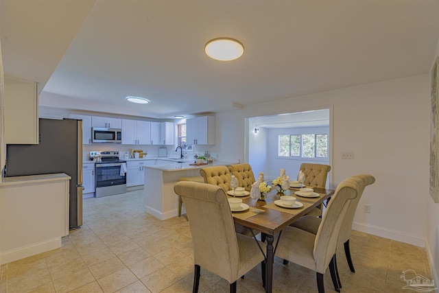 dining room with light tile patterned floors and baseboards